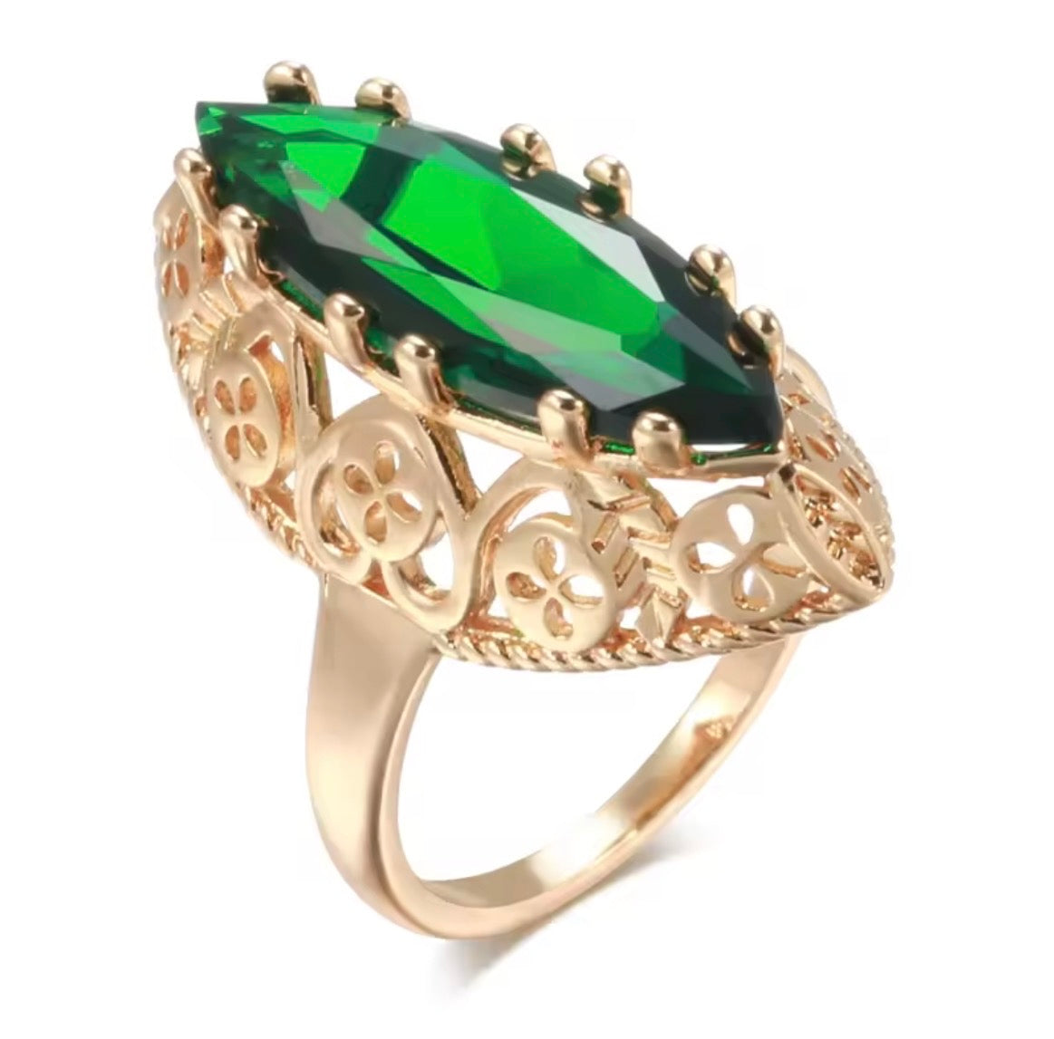A gold ring featuring a large marquise-cut green gemstone in an ornate filigree setting, shown on a clean white background.
