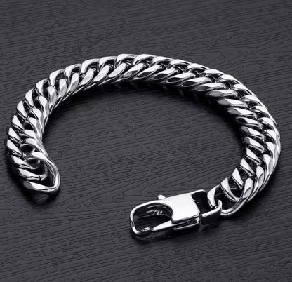 Silver chain bracelet on a dark textured surface